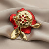 Backside of red rose brooch on a ivory fabric background