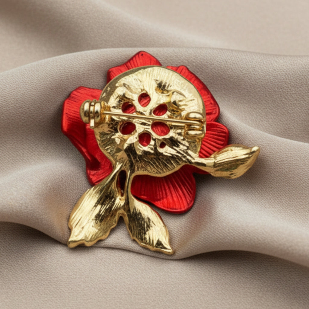 Backside of red rose brooch on a ivory fabric background