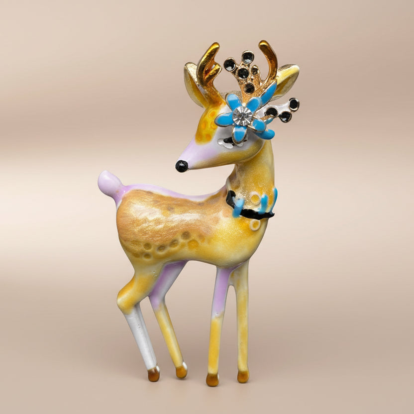 Decorative deer brooch with colorful antlers on a soft white background