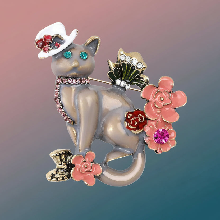 Cat-shaped brooch with decorative elements on a pastel background
