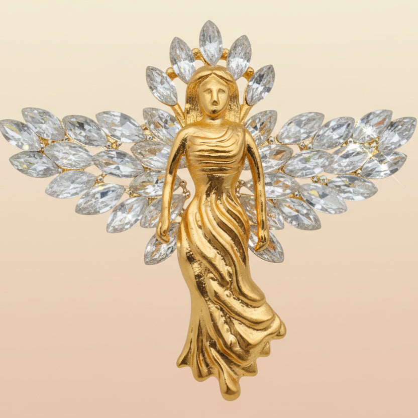 Gold angel with crystal wings brooch on a pastel background