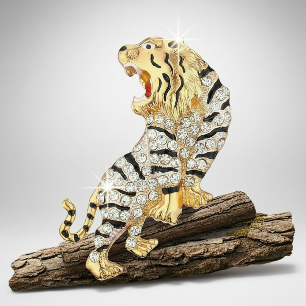 Gold and black rhinestone tiger brooch positioned on a wood log on a light gray background