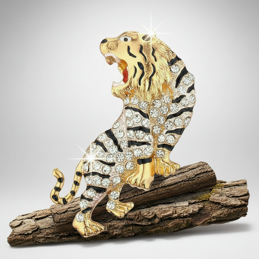 Gold and black rhinestone tiger brooch positioned on a wood log on a light gray background