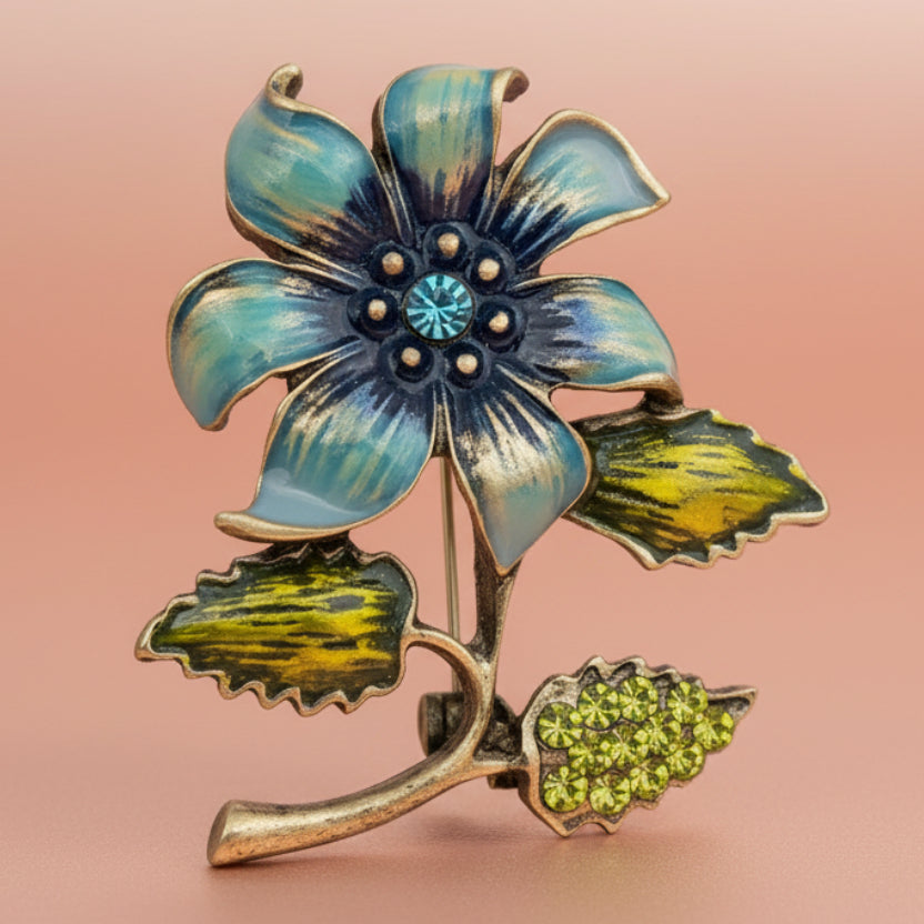 Floral brooch with blue and green colors on a light pink background