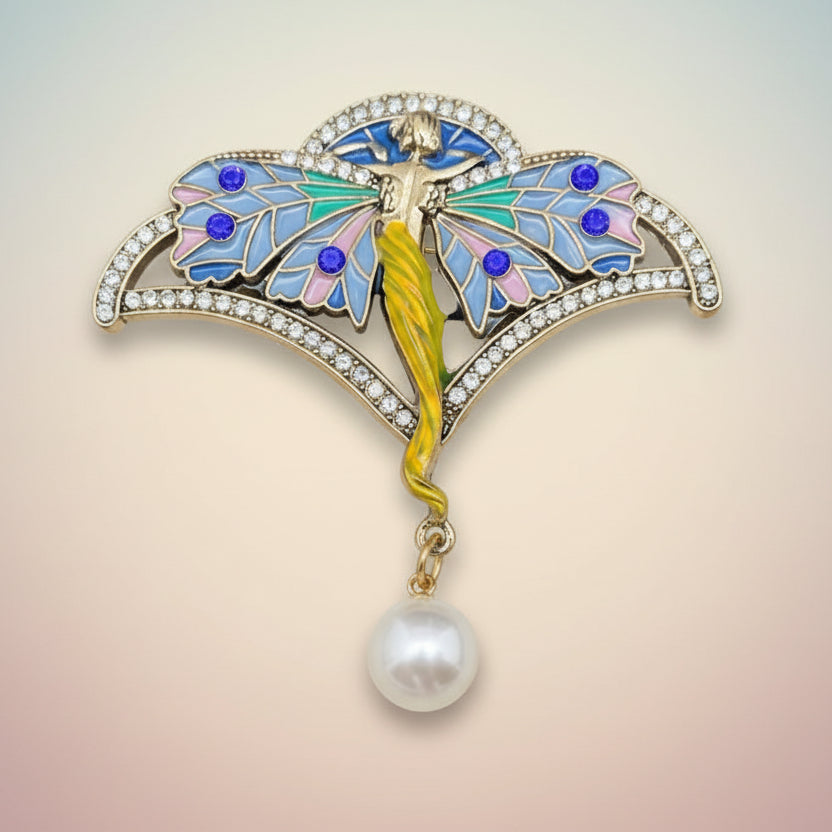 Nymph brooch with colorful butterfly design and pearl on a soft white background