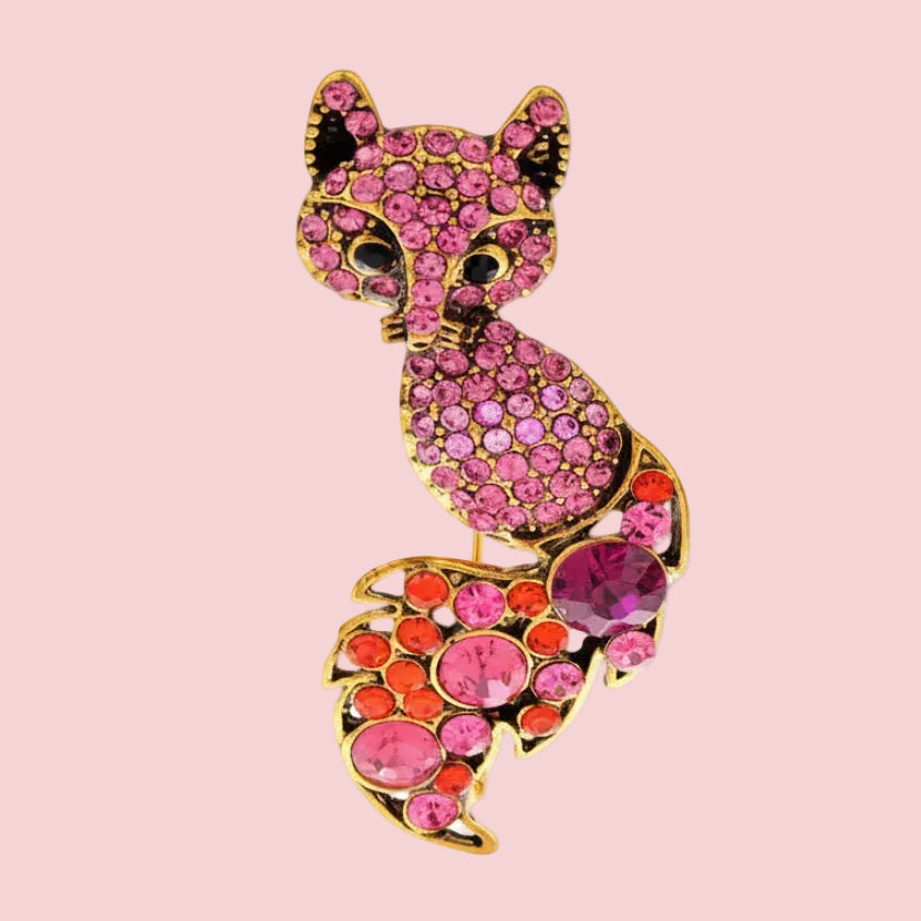 Colorful fox-shaped brooch on a white background