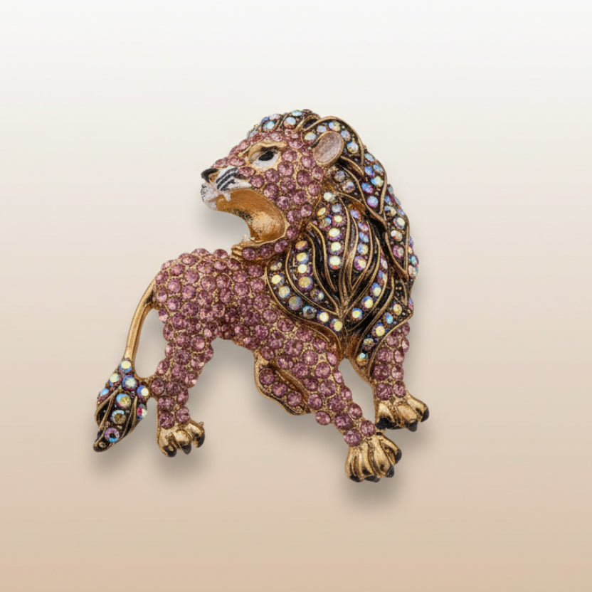 Pink and gold rhinestone lion brooch on a soft white background