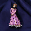 Lavender dancing lady brooch with purple accents on a navy satin background
