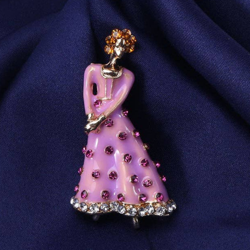 Lavender dancing lady brooch with purple accents on a navy satin background