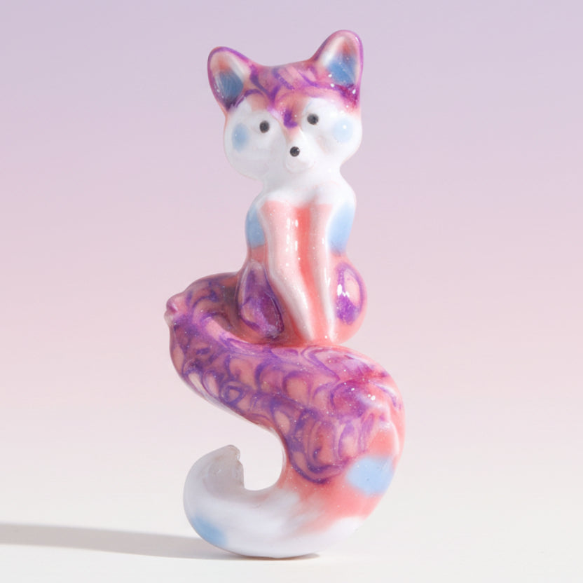 Colorful fox brooch on a white background