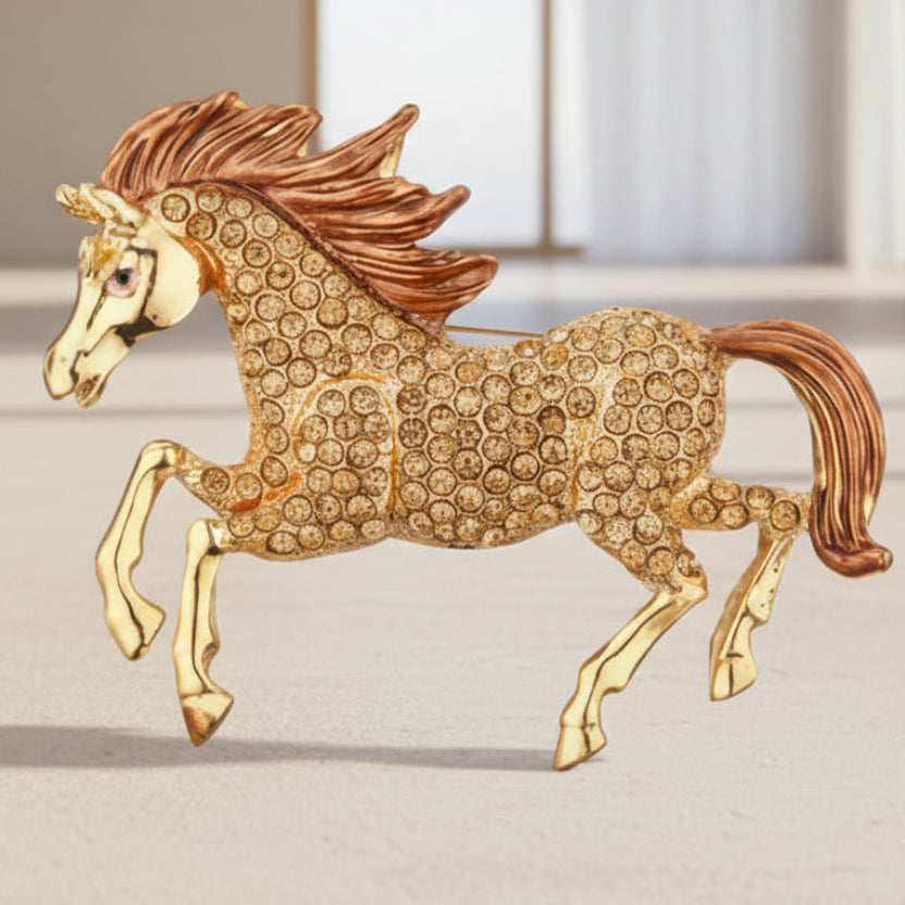 Champagne-colored rhinestone mustang horse brooch on a studio background