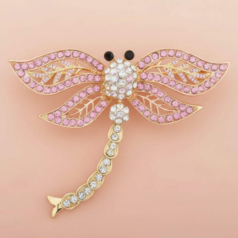 Pink and white rhinestone firefly brooch on a pastel pink background
