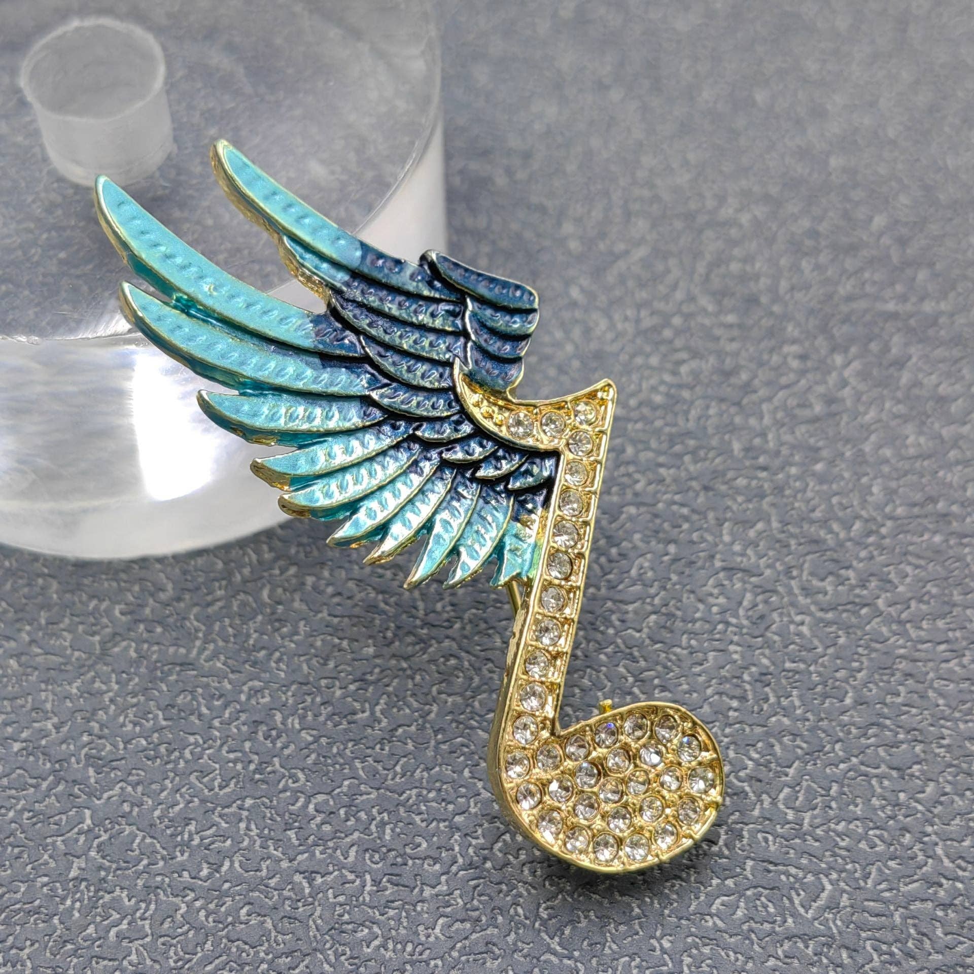 Winged Rhinestone Musical Note Brooch